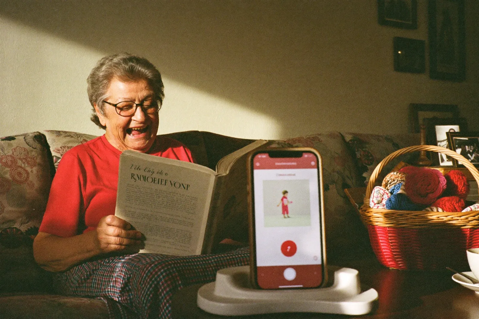 A mother tucking a child into bed, a phone on the nightstand